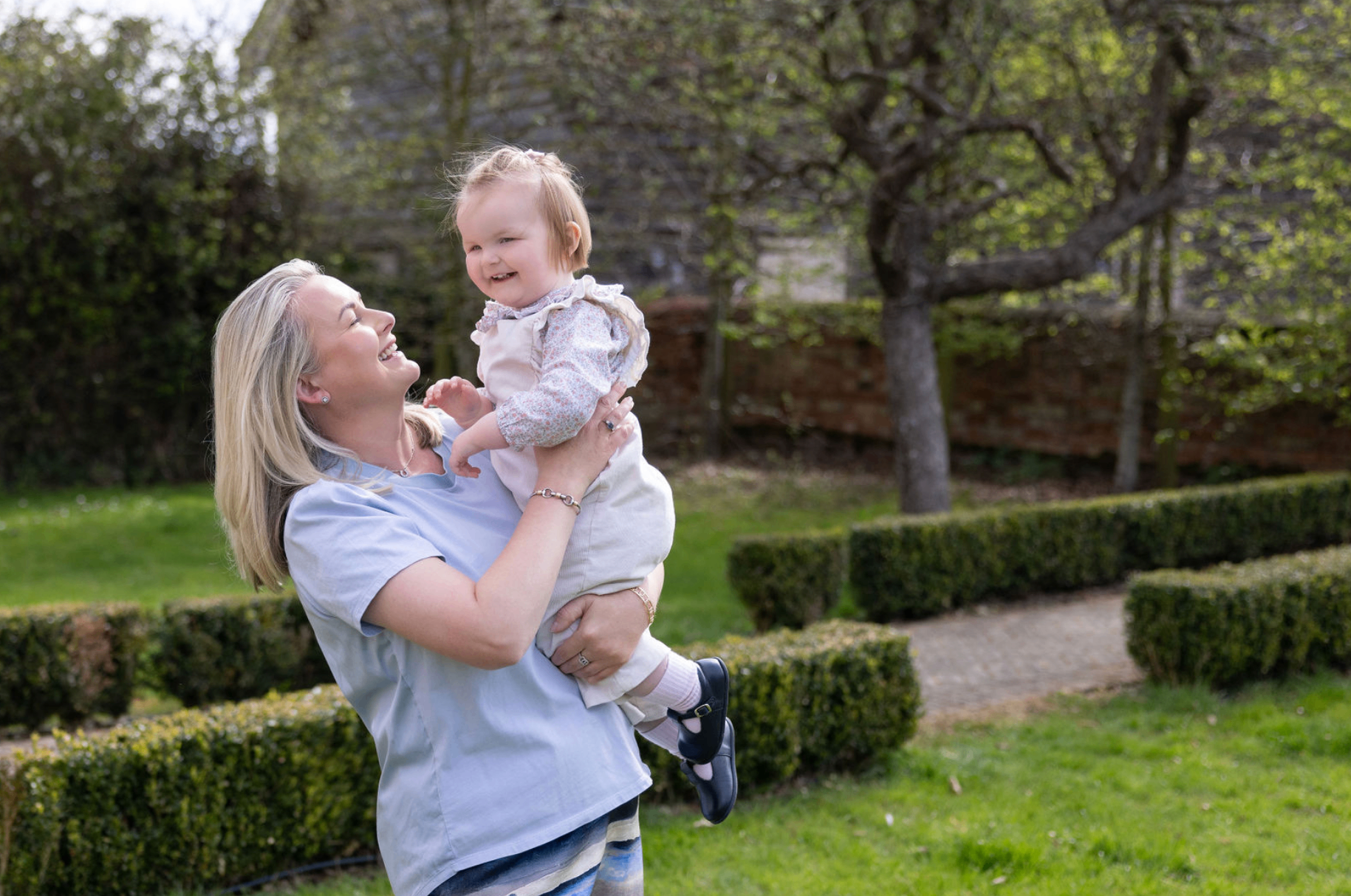 Louenna Hood — childcare expert and partner of The Mortgage Genie, pictured with a happy young family at home